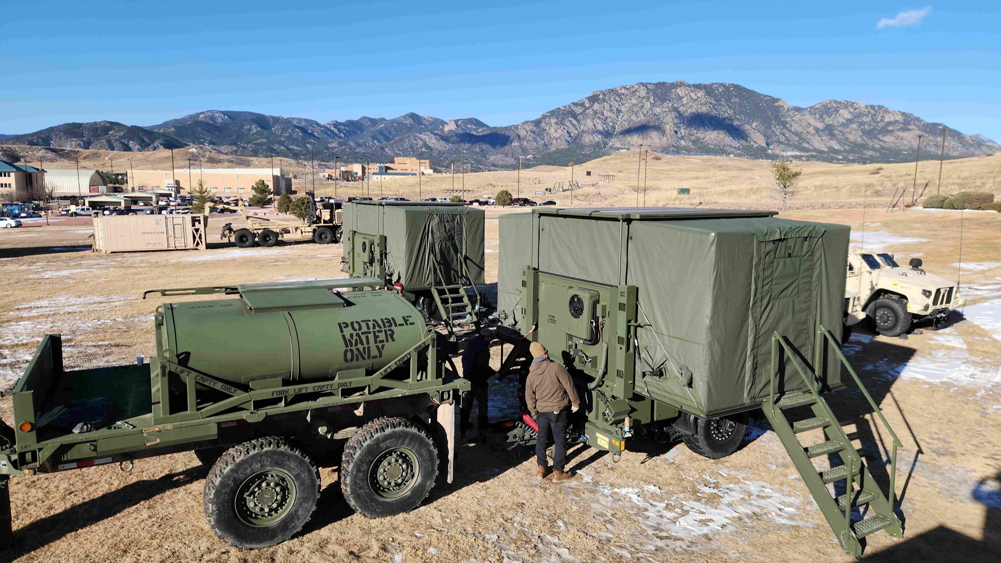 Kitchen trailers and a water trailer set up in the field